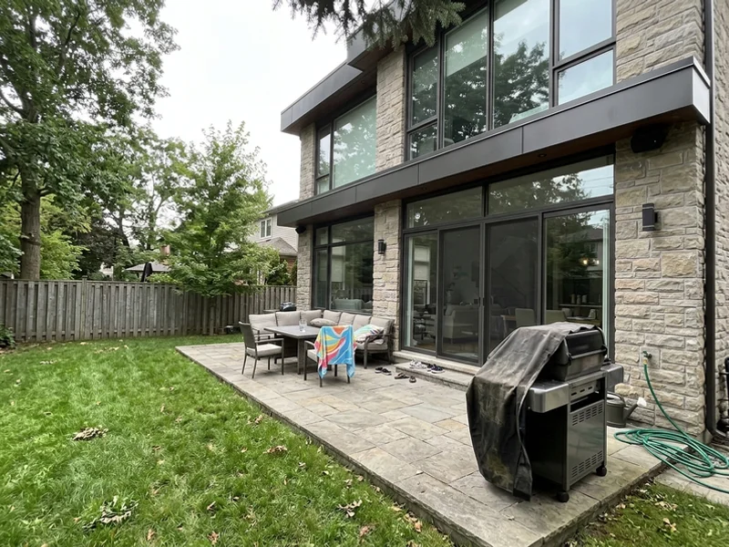 Bronte modern home rear elevation with glass and stone terrace