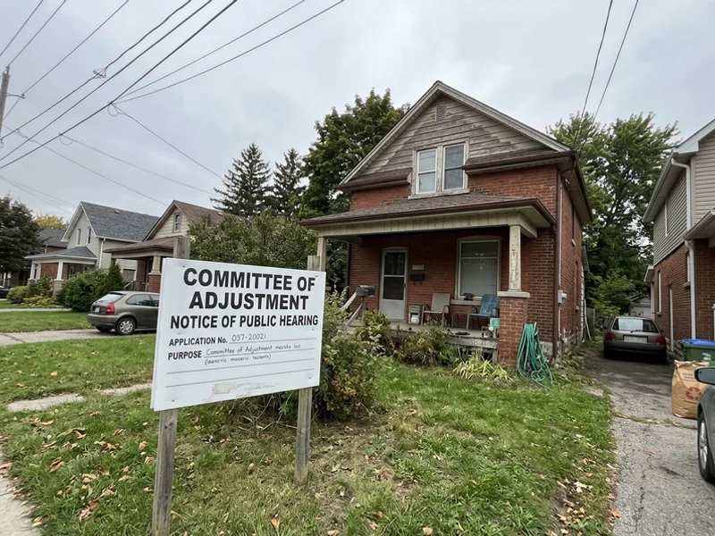 Committee of Adjustment notice sign on an infill lot