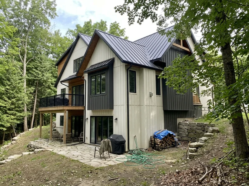 Farmhouse-contemporary custom home with a walkout on a sloped Tyandaga ravine lot