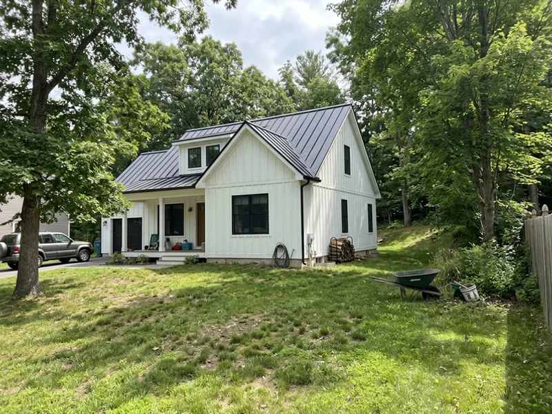 Farmhouse-contemporary home with standing seam metal roof