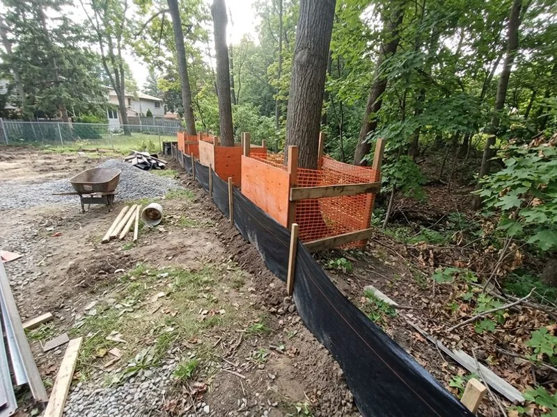 Silt fence and tree protection along a ravine edge