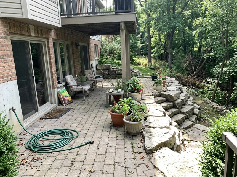 Walkout lower level following the natural slope toward a ravine