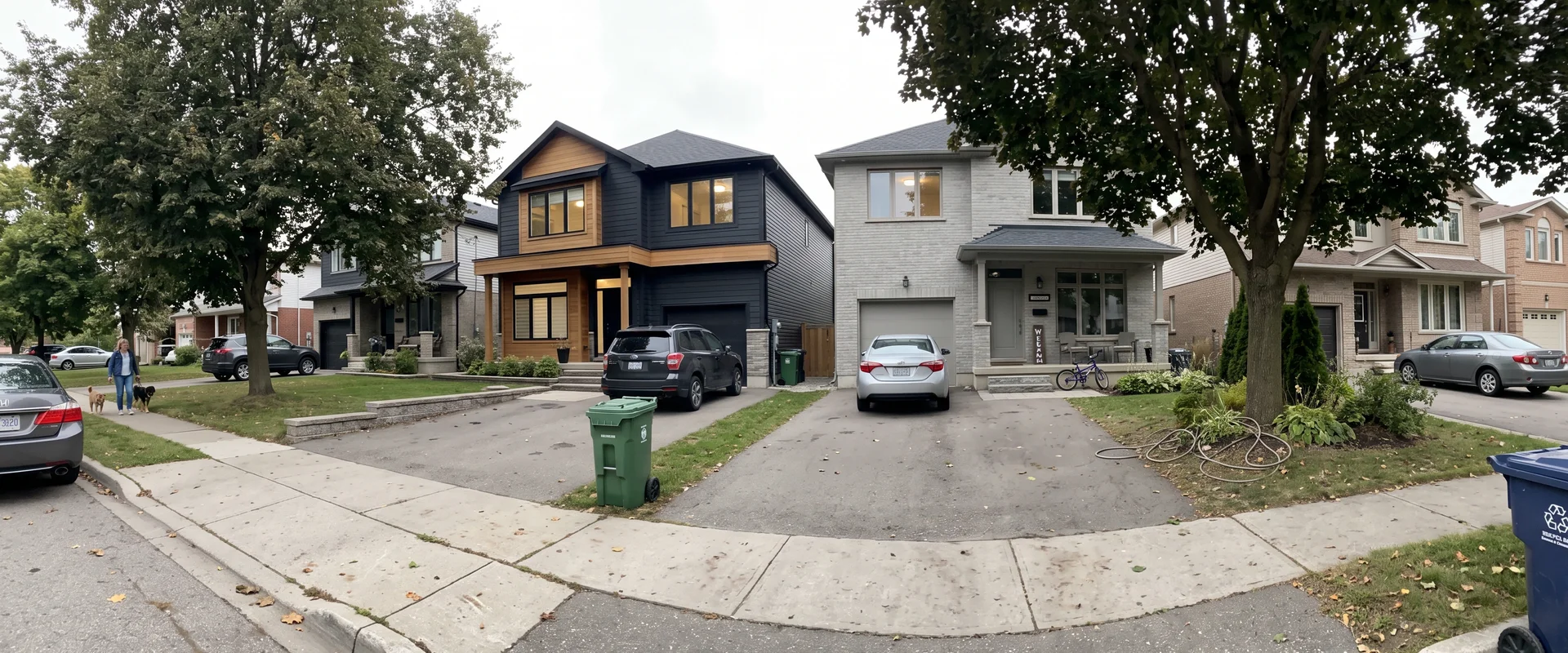 Completed custom homes on an established Burlington street at dusk