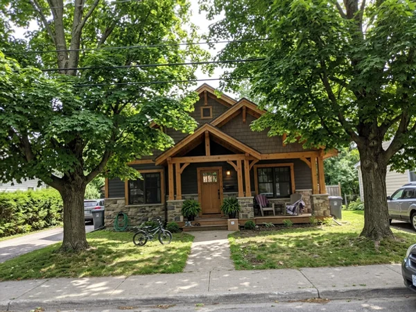 After: Craftsman custom home between preserved maples in Roseland at dusk