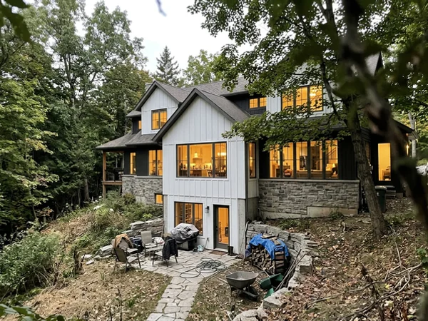 After: farmhouse-contemporary home with walkout on a Tyandaga ravine slope at dusk
