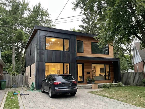 After: modern steel and cedar custom home in Bronte at dusk