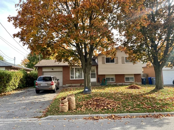 Before: dated side-split under two mature maples in Roseland
