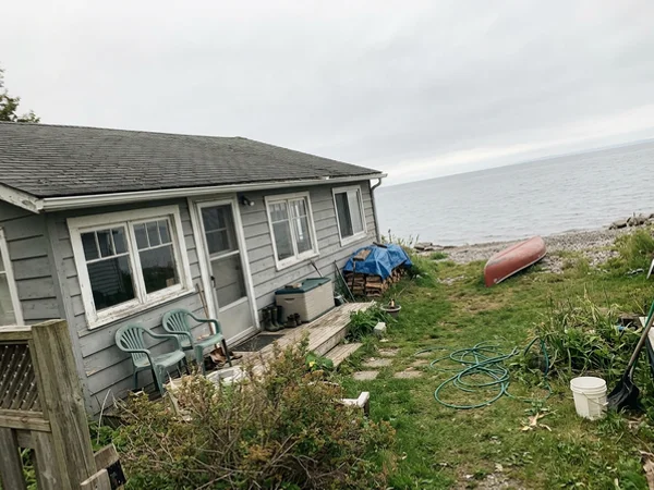 Before: older cottage-style house on a Lake Ontario parcel