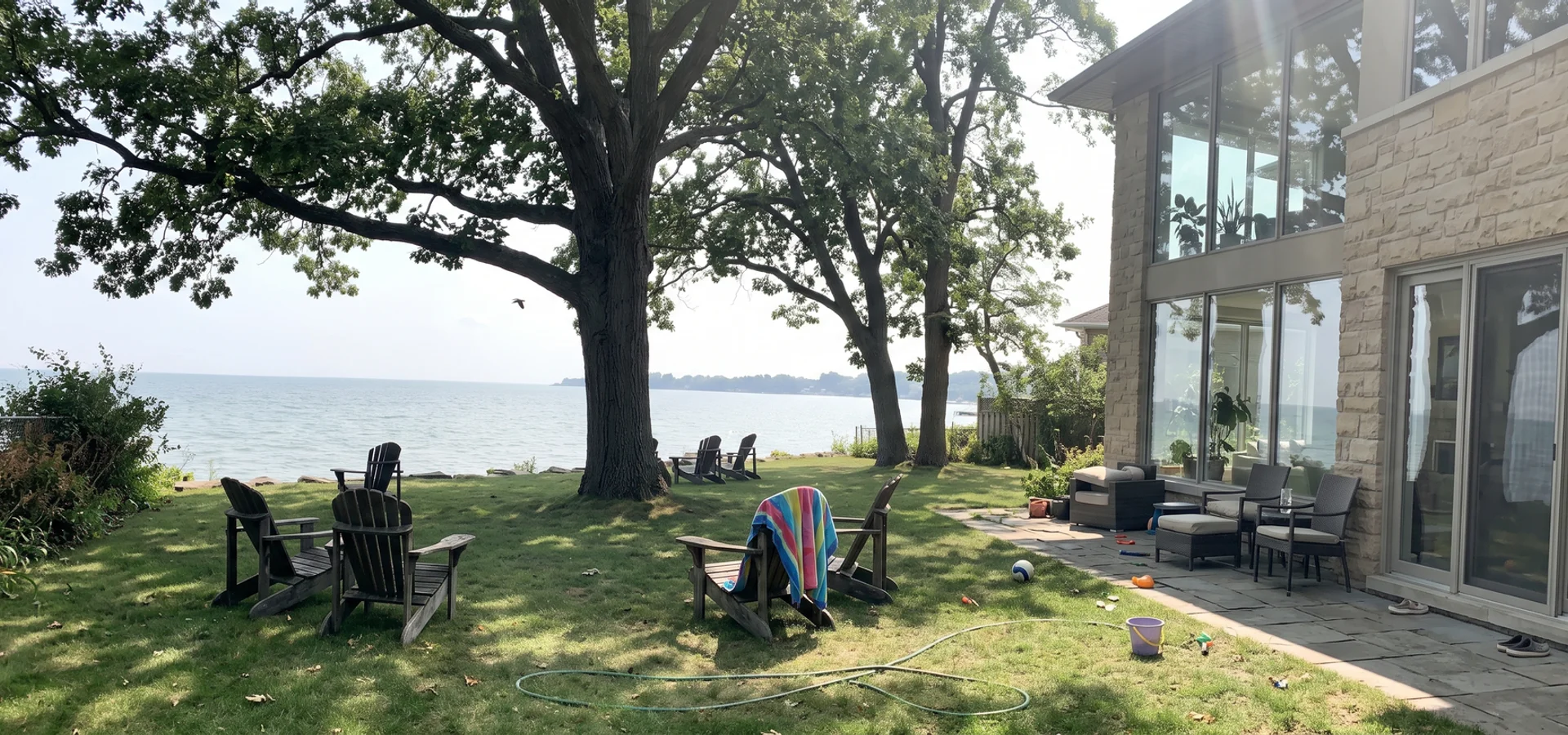Luxury limestone and glass custom home on the Burlington waterfront at golden hour