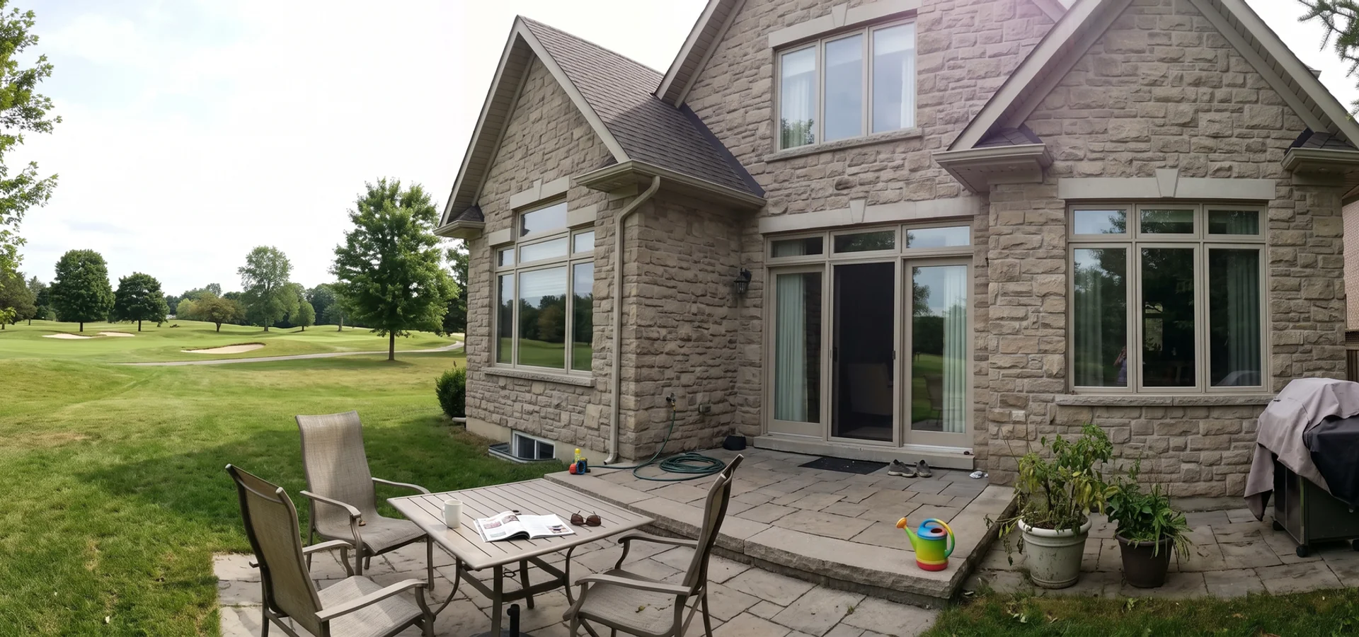 Luxury stone custom home backing onto the Millcroft golf course at dusk