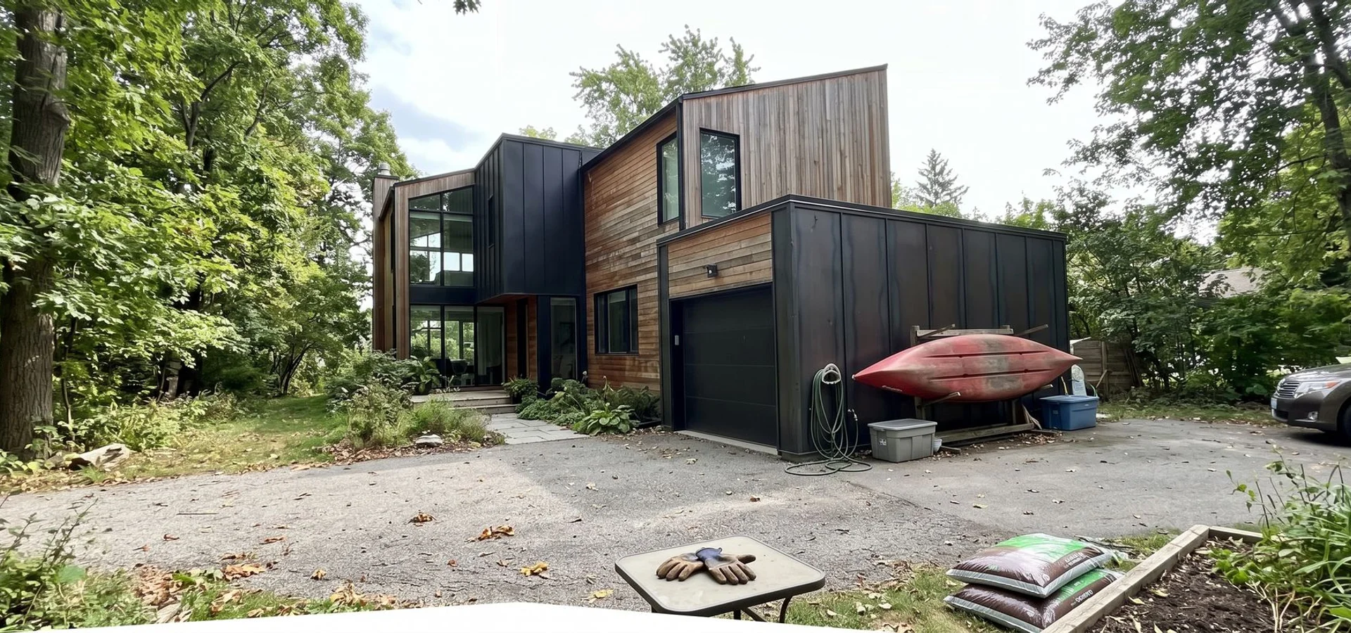 Modern custom home with blackened steel and cedar on a treed South Oakville lot