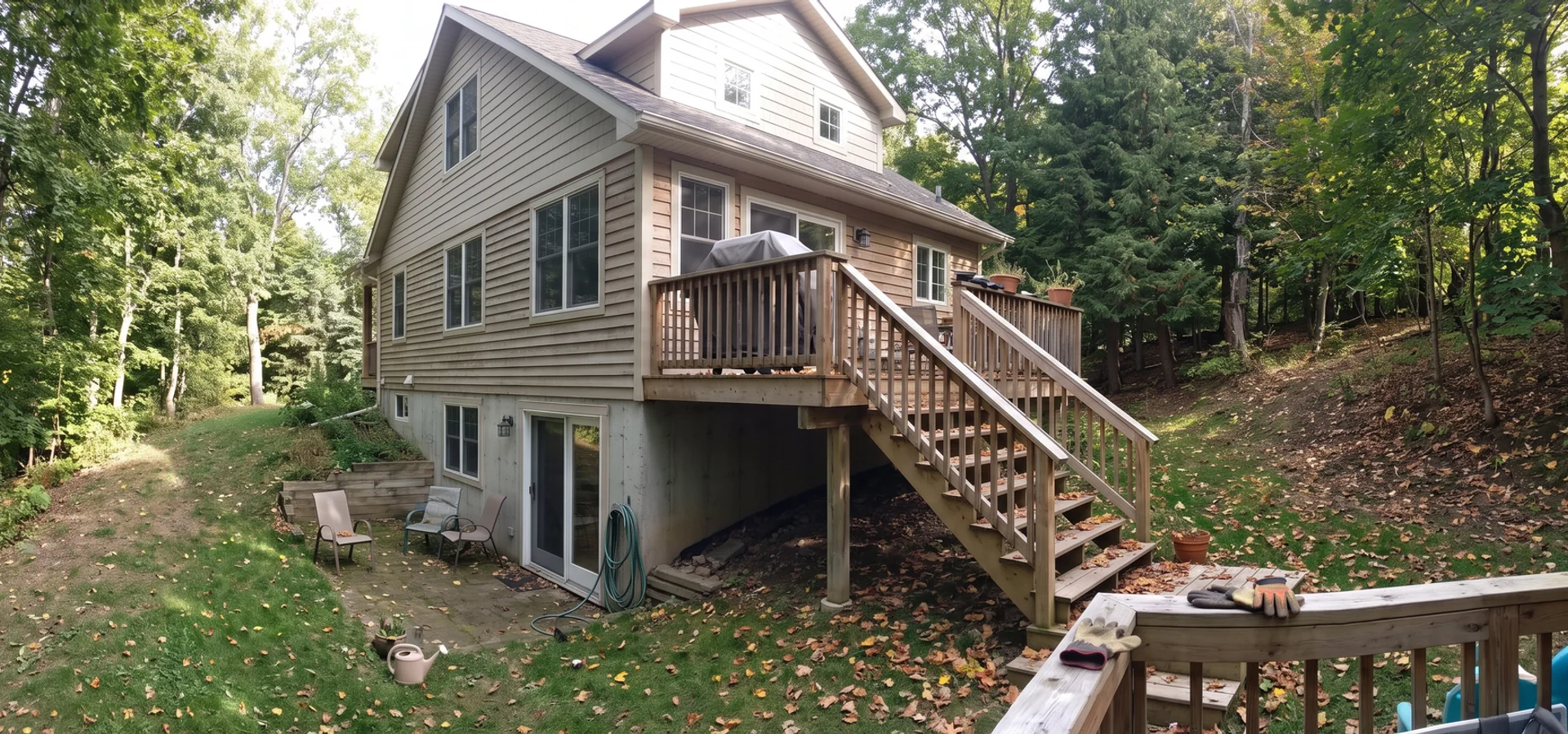 Farmhouse custom home with a walkout on a wooded Tyandaga ravine lot